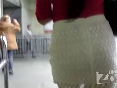 Tanned babe in white knit skirt.